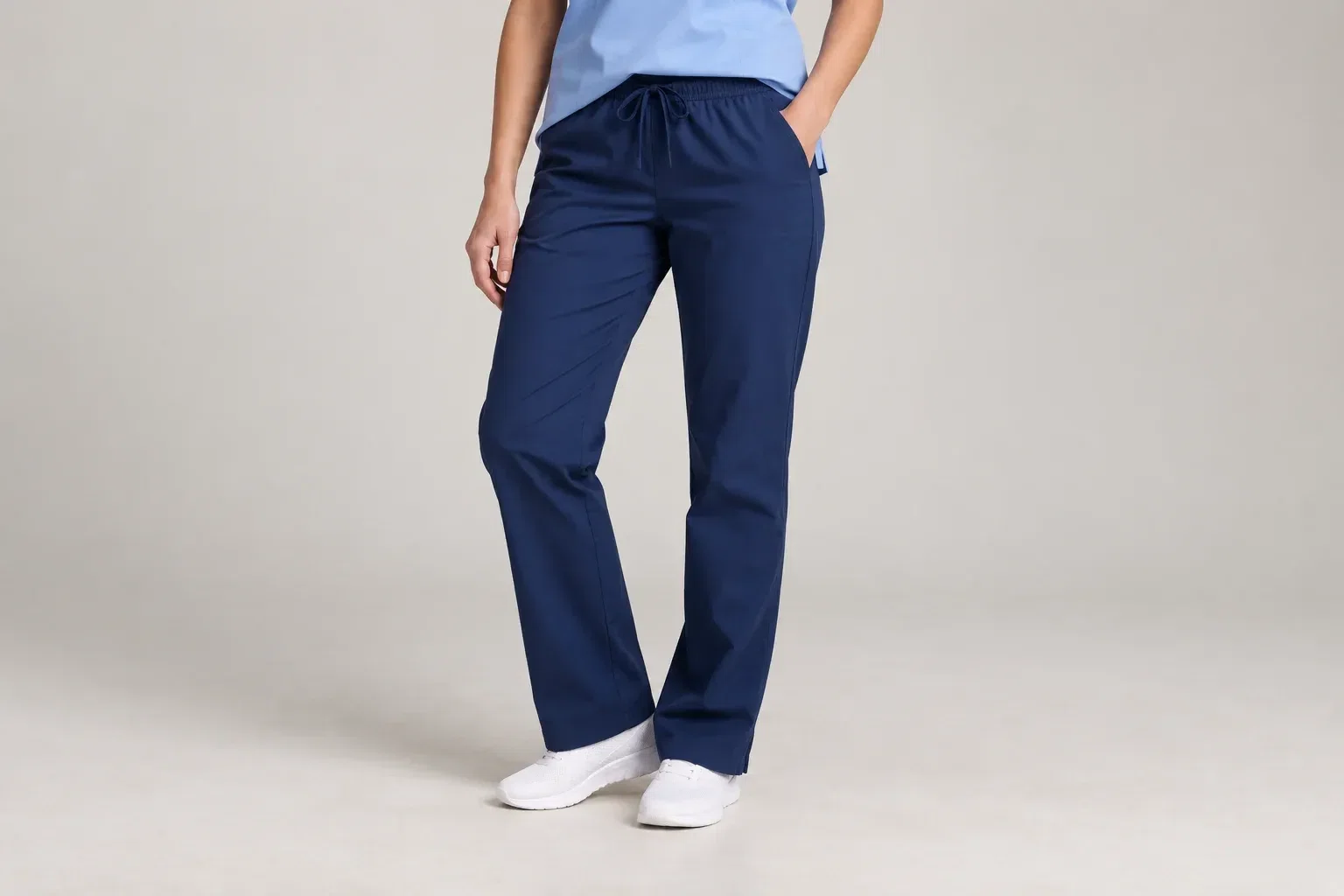 illustrative studio image focused on a model wearing plain navy scrub trousers