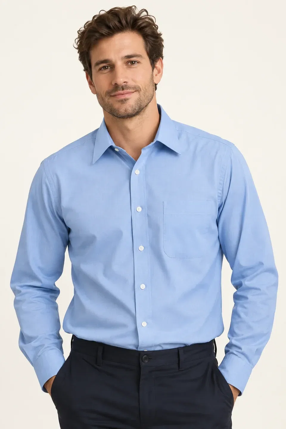 illustrative studio image of a model wearing a plain light blue button-down shirt