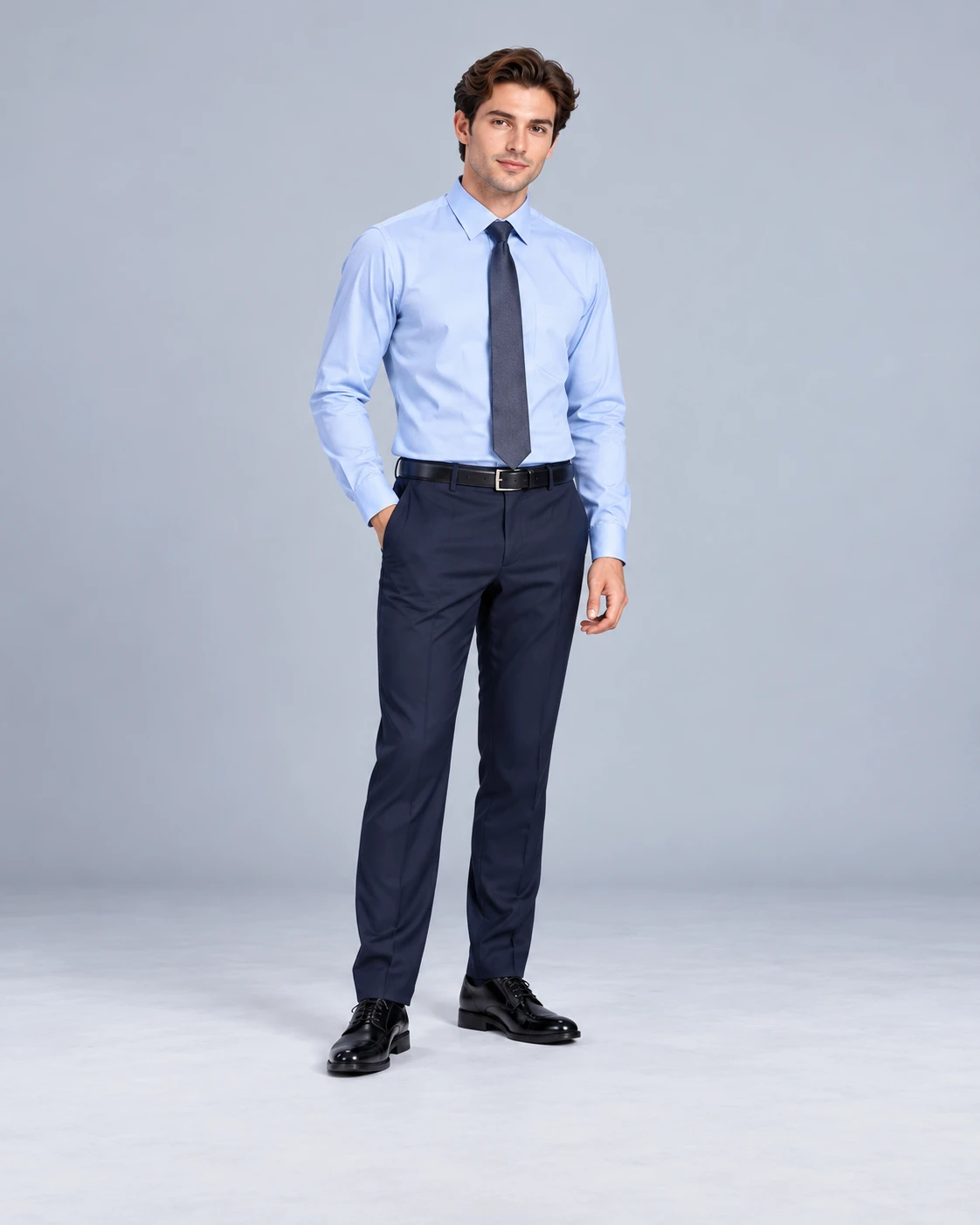 an office professional wearing a light blue shirt, navy tie and tailored trousers