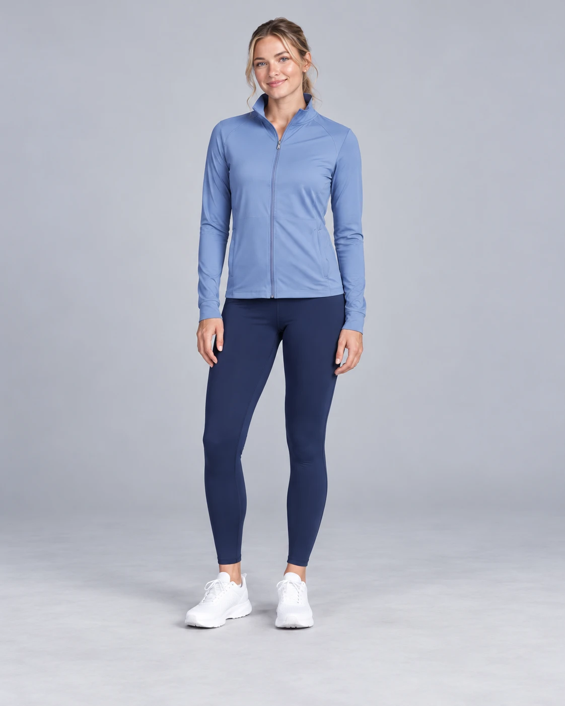 a gymwear model wearing a light blue training jacket and navy leggings