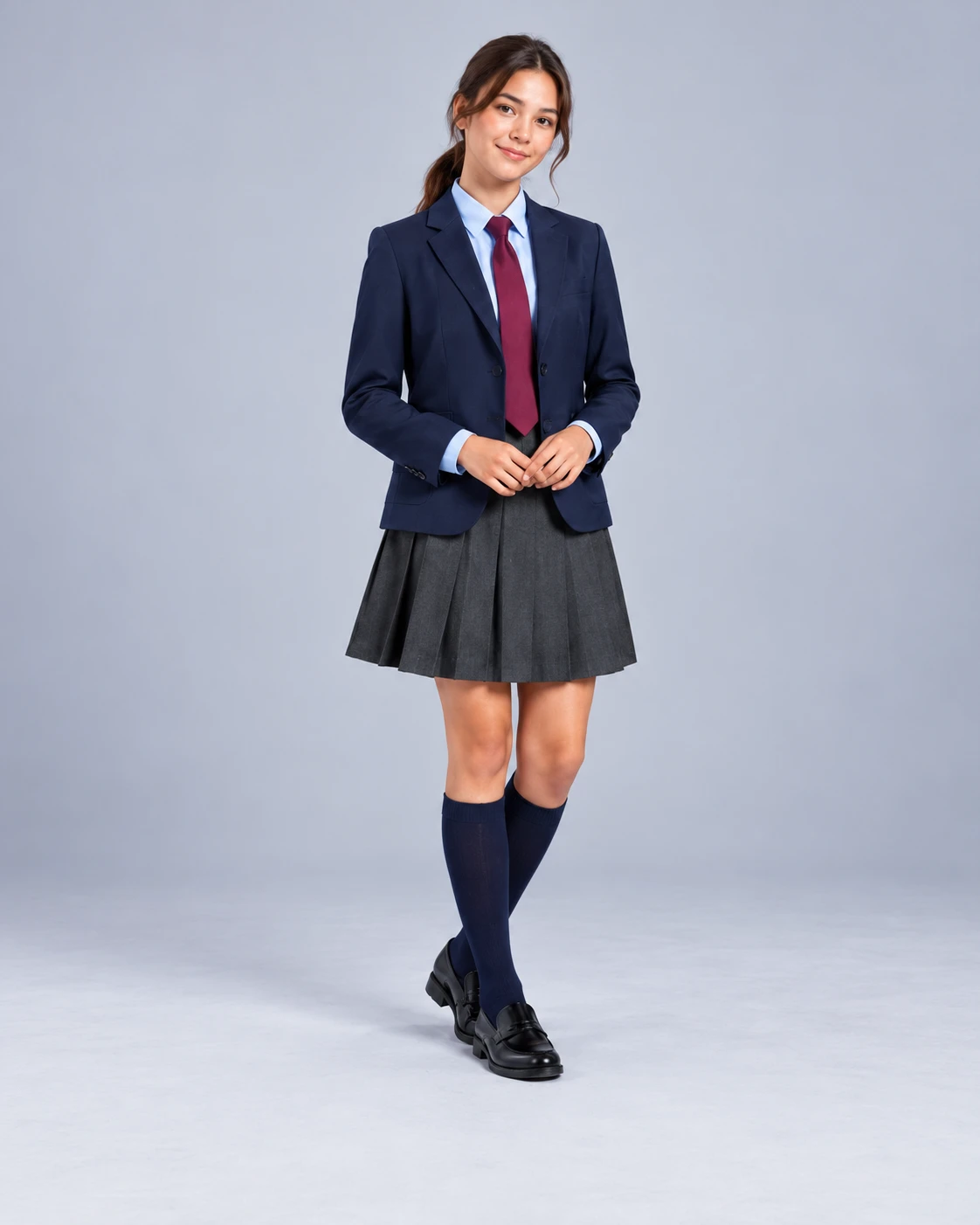a student wearing a navy school blazer, burgundy tie and pleated skirt
